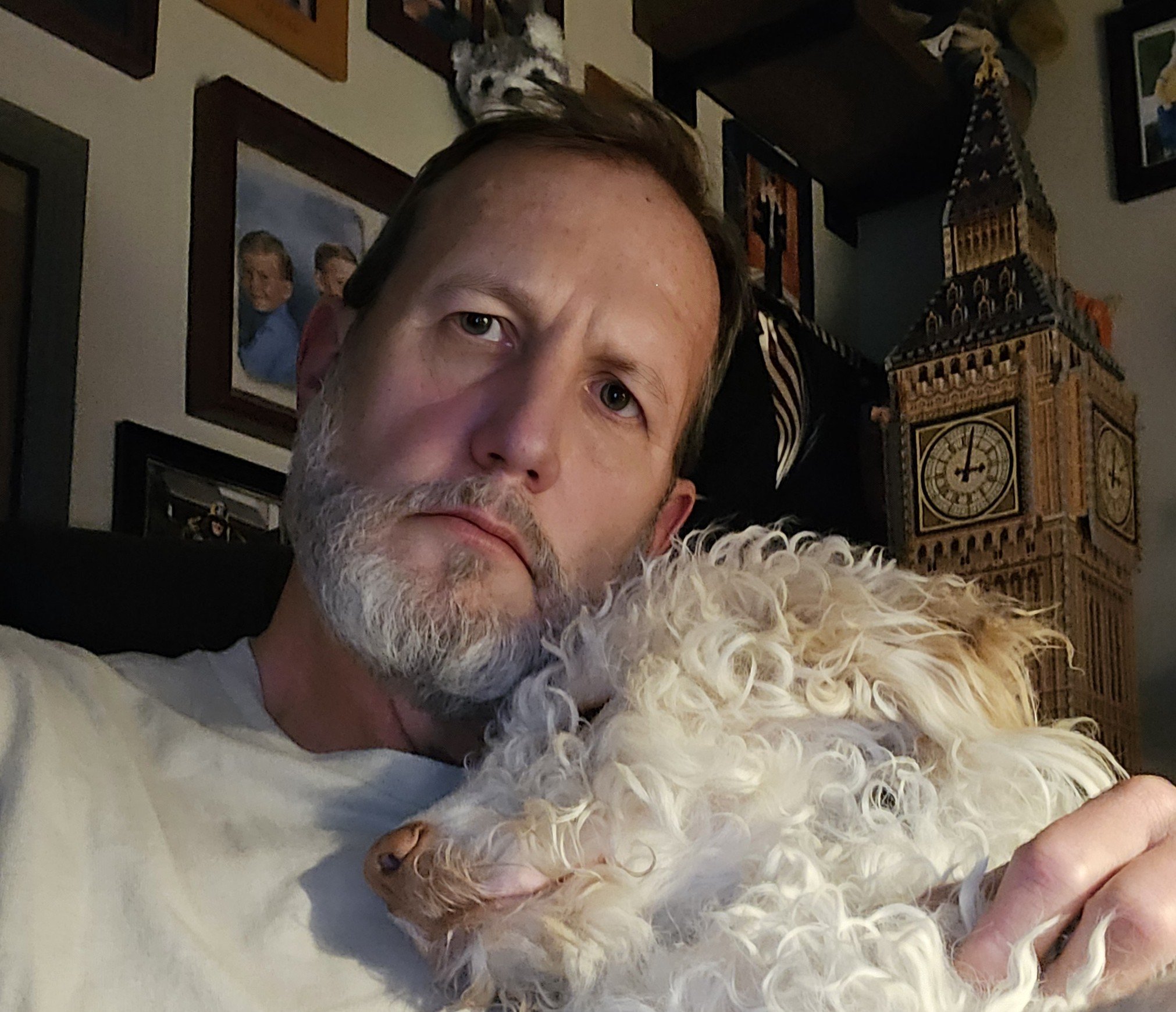 Sage Cole relaxing at home with one of his dogs